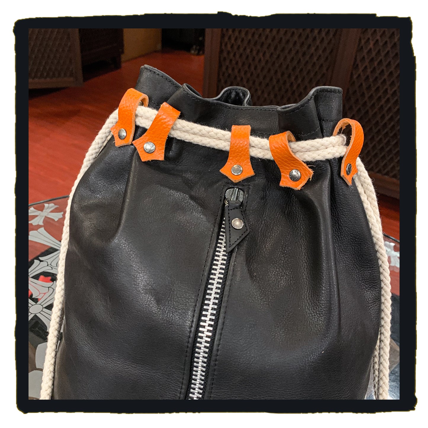 20-bp003a leather sport backpack with suede fleur de lys patch