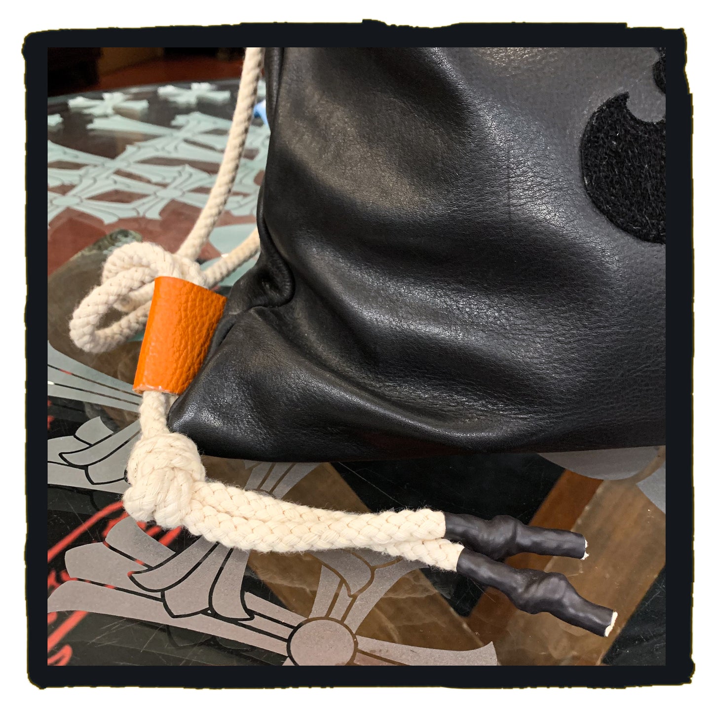 20-bp003a leather sport backpack with suede fleur de lys patch